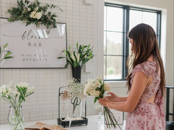 Wedding guest creating a bouquet at Selah Floral Studio's interactive bloom bar during a Central Pennsylvania wedding.
