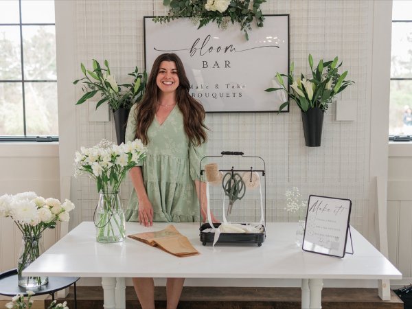 Selah Floral Studio owner standing behind a custom wedding bloom bar featuring make-your-own bouquets in Central Pennsylvania.