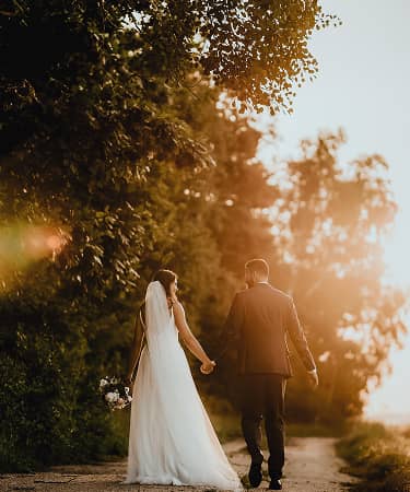 wedding couple walking into the sunset