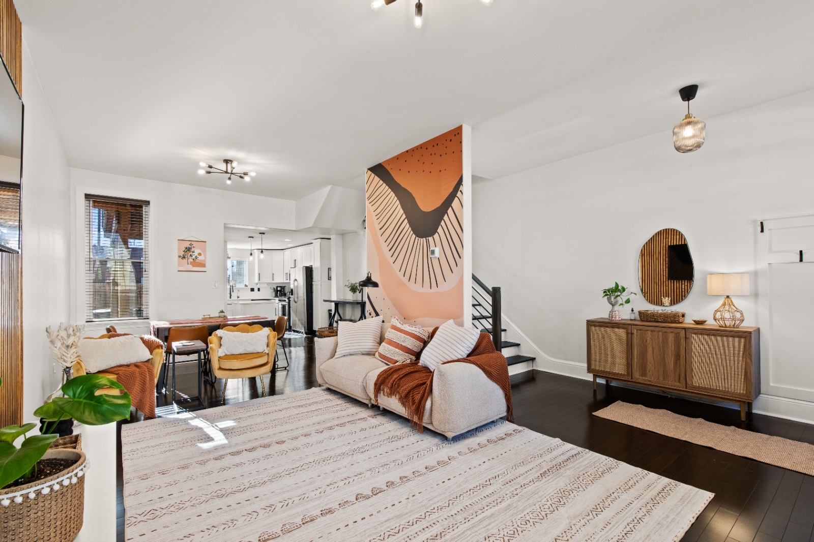 Luxury on Lemon Living Room in Lancaster PA Open concept living room at Luxury on Lemon Airbnb in Lancaster, PA with abstract mural wall, cozy seating, and modern decor.