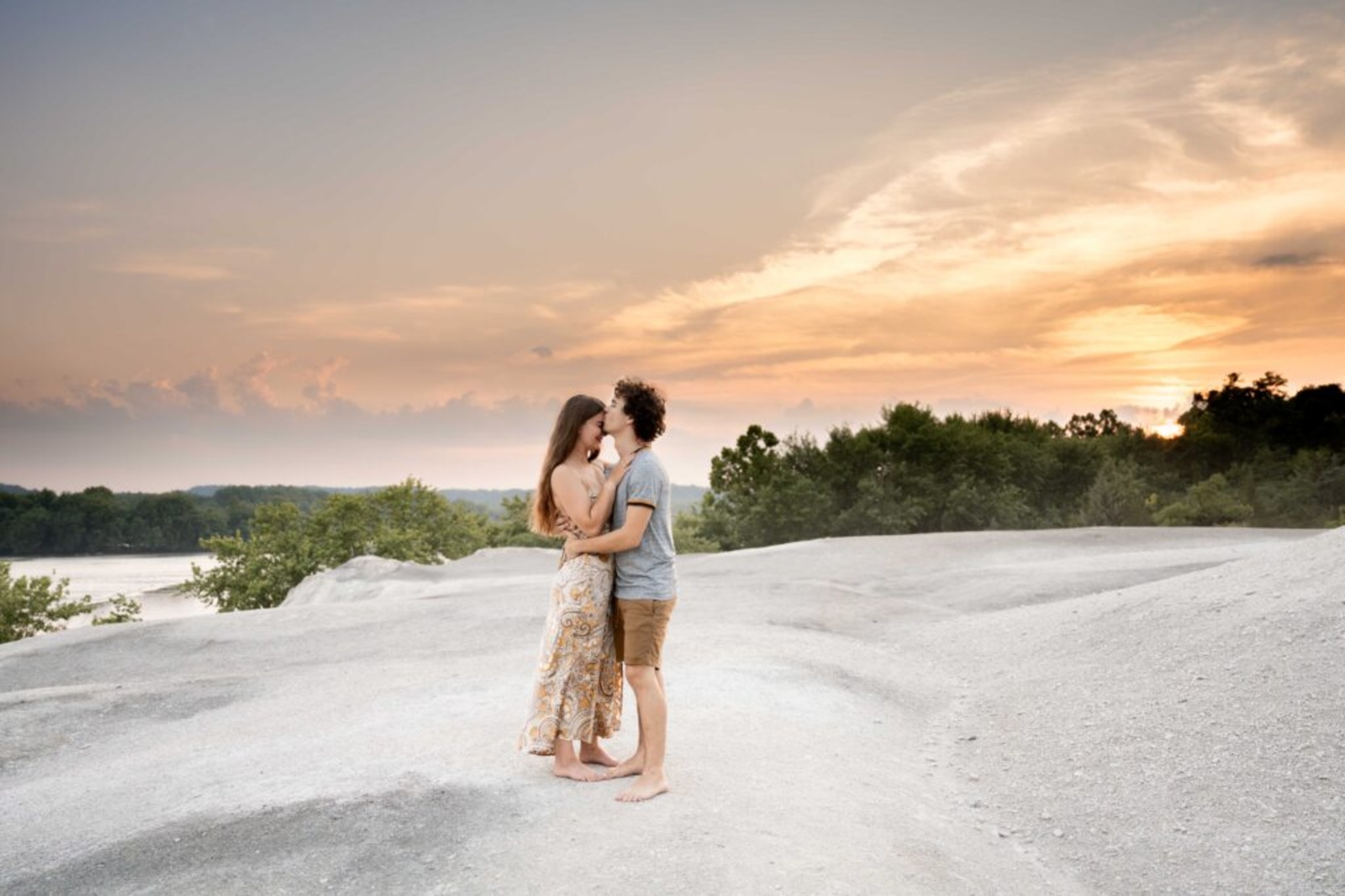 Couple embracing on the White Cliffs of Conoy overlooking the Susquehanna River at sunset in Lancaster County, Pennsylvania.