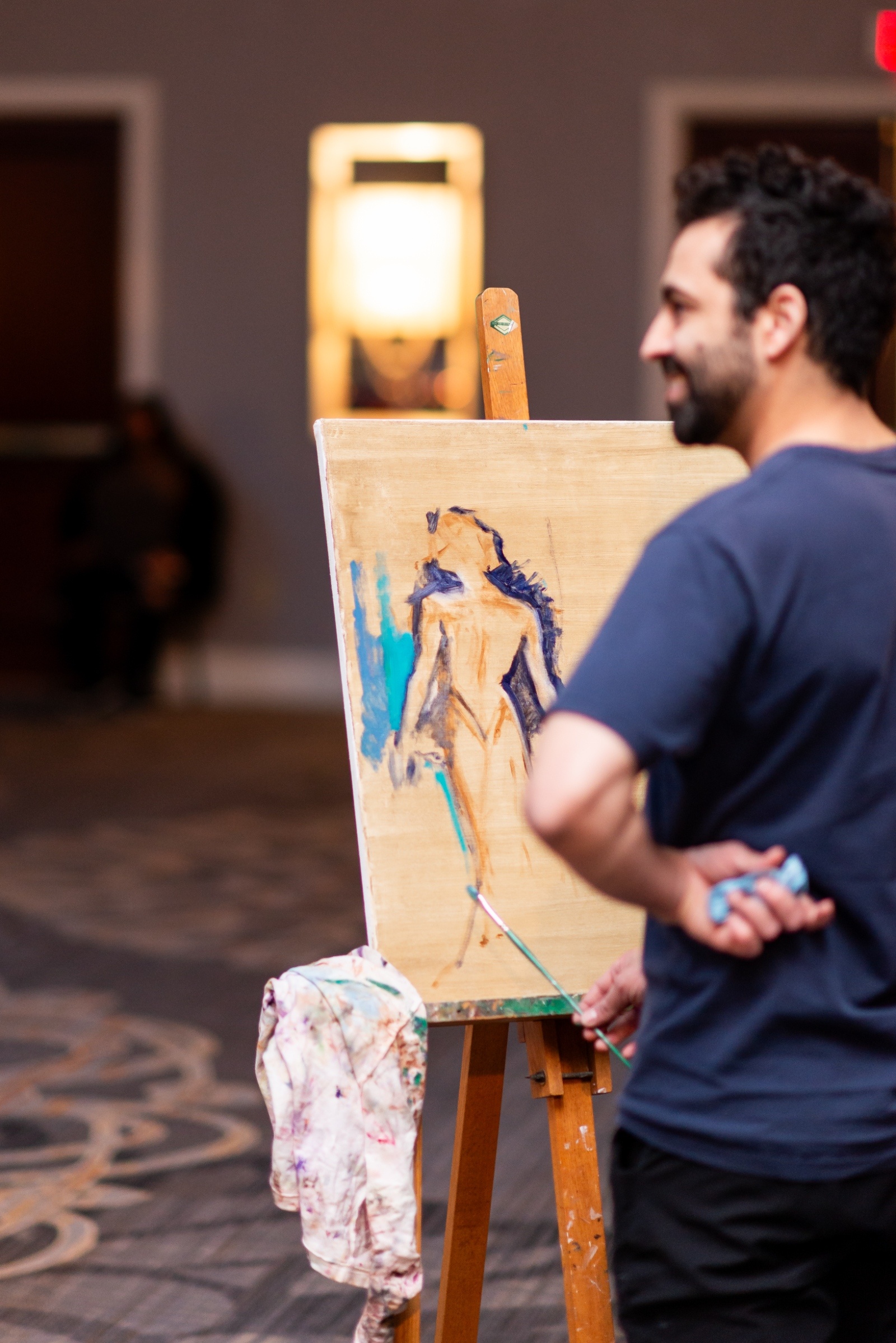 Live wedding painter creating an artistic portrait of the bride during the reception at a modern Pennsylvania wedding.