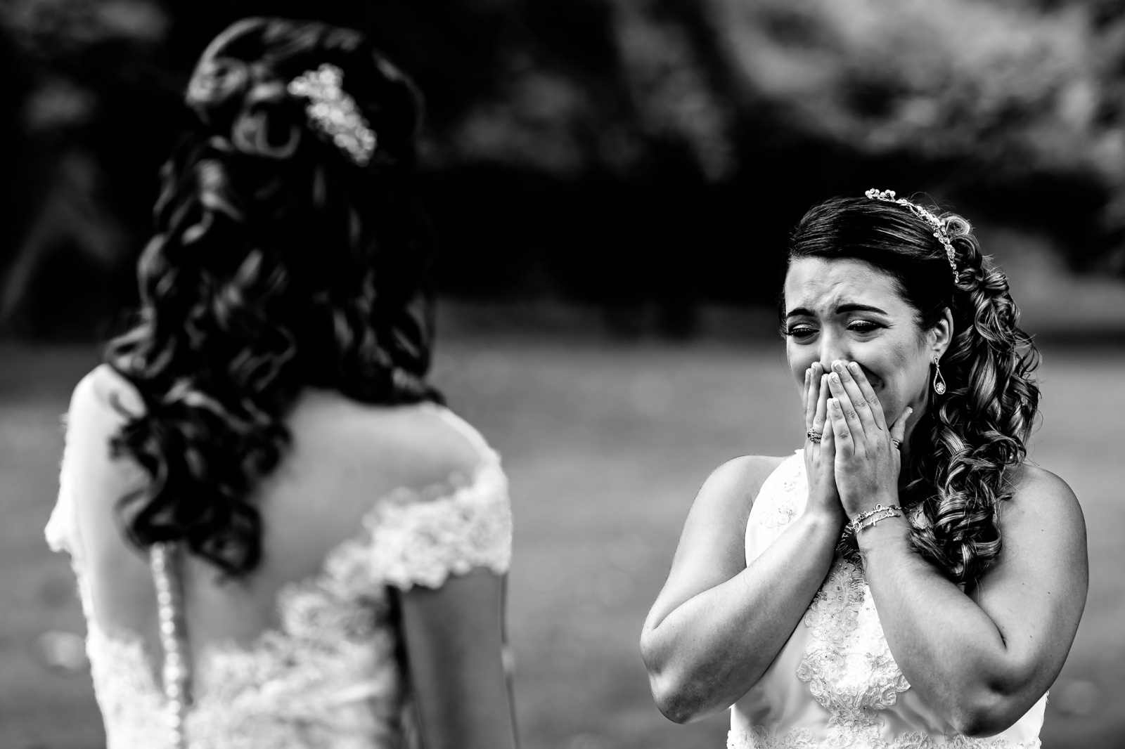 Mother of the bride crying during first look of the bride in black and white