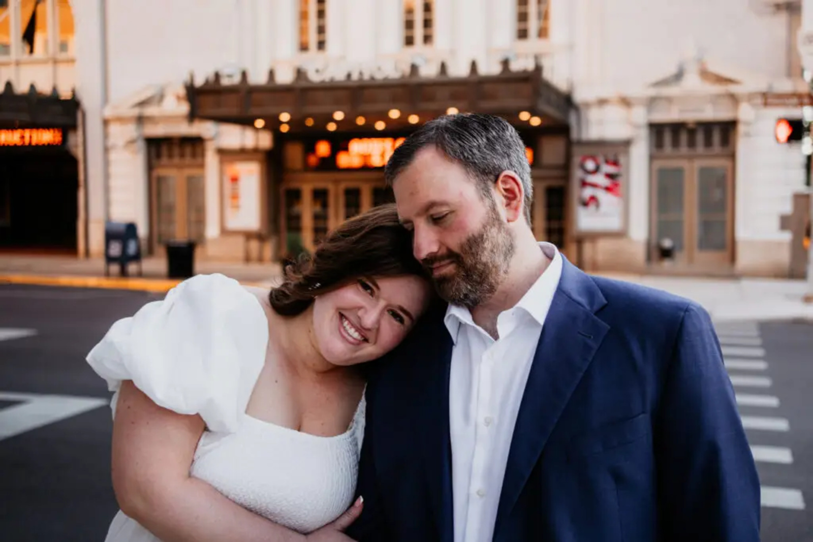 Couple embracing in front of the historic Capitol Theatre marquee in York, Pennsylvania, captured during their timeless city engagement session.