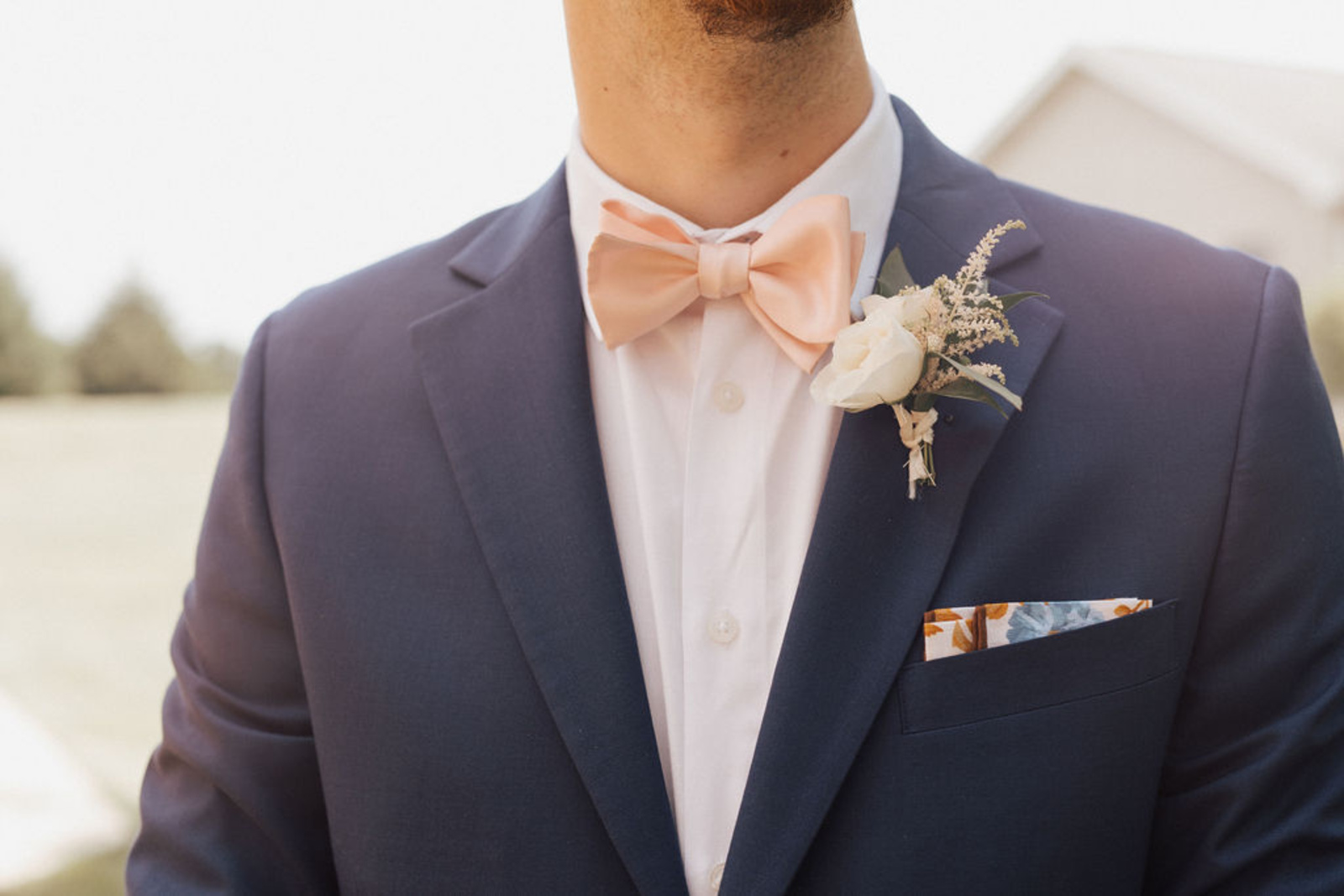 Navy blue jacket with floral pocket square and light pink bow tie of Central PA groom
