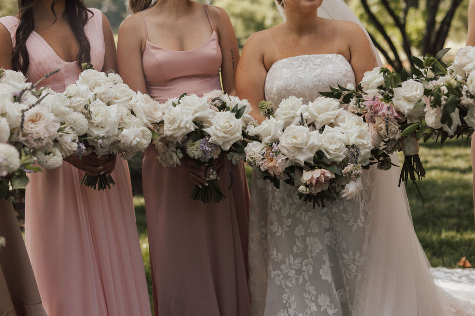 Central PA bride and bridesmaids holding large bouquets with beautiful white roses