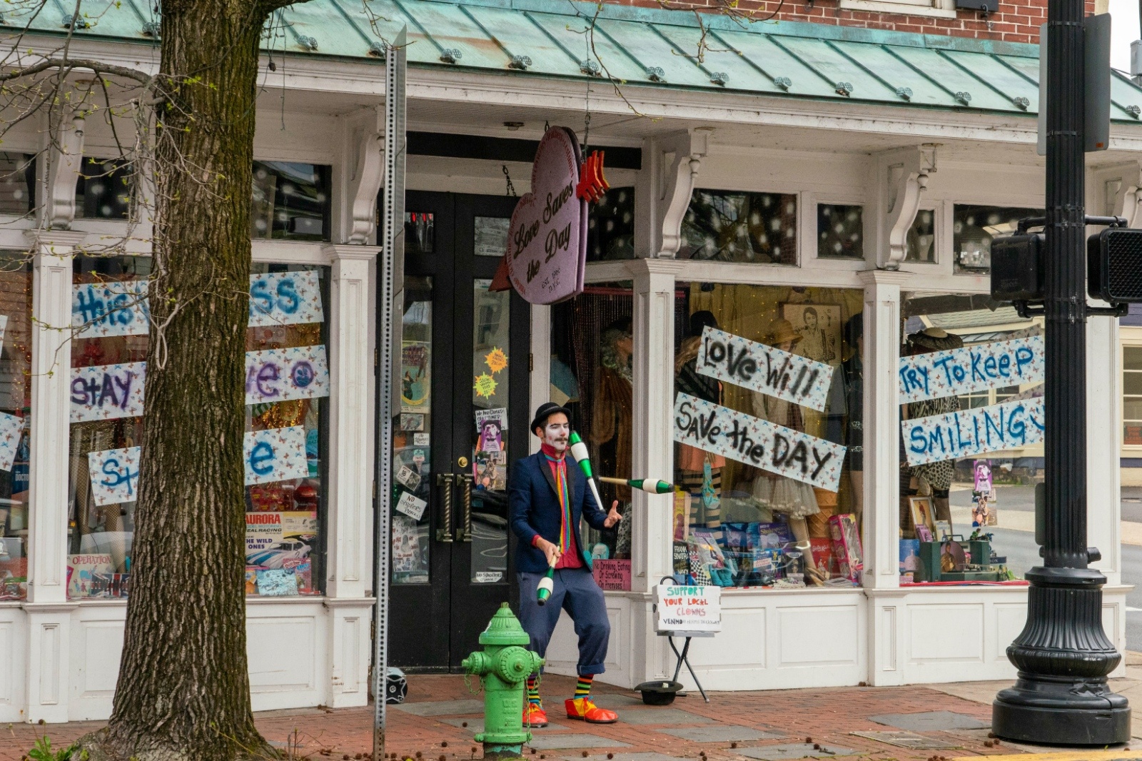 Colorful downtown street in New Hope, Pennsylvania with a performer outside a local shop, capturing the artsy, walkable vibe perfect for a relaxed bachelorette weekend.