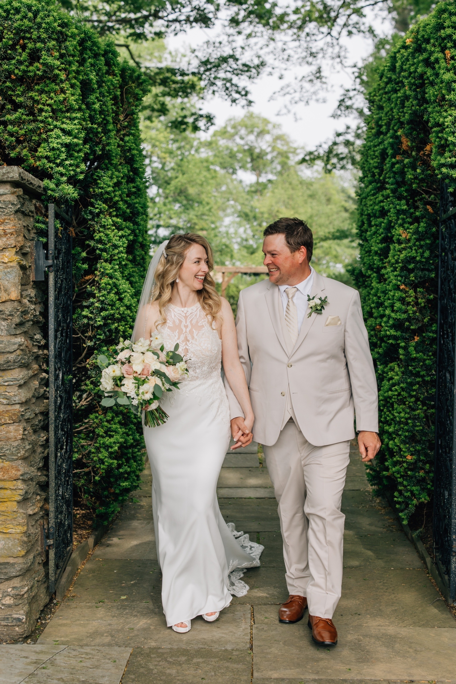 Garden Wedding Portrait at Drumore Estate Bride and groom walking through lush gardens at Drumore Estate wedding venue in Pequea Pennsylvania