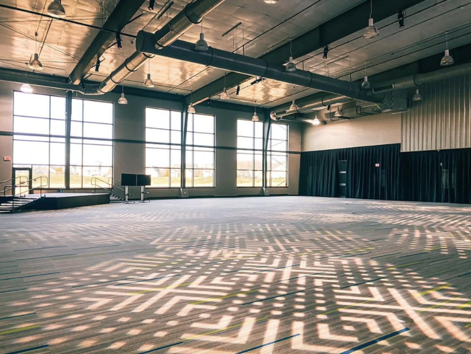 Foundry48 Industrial Wedding Venue in Lititz, PA Spacious industrial event hall at Foundry48 in Lititz, PA, featuring oversized windows, exposed ductwork, and high ceilings.