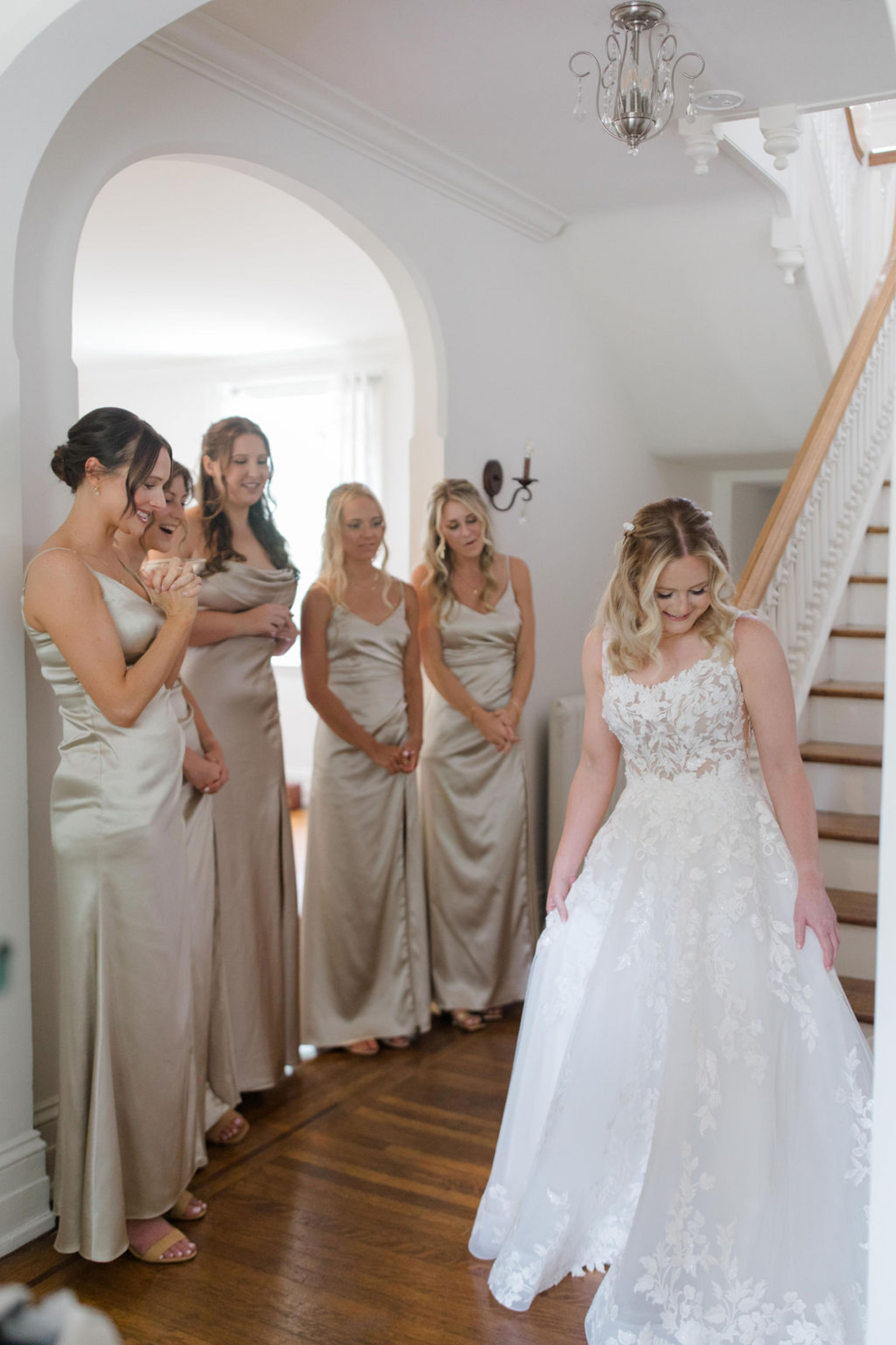 Bridesmaids reacting to the bride in her floral lace wedding gown inside Historic Ashland before the ceremony.
