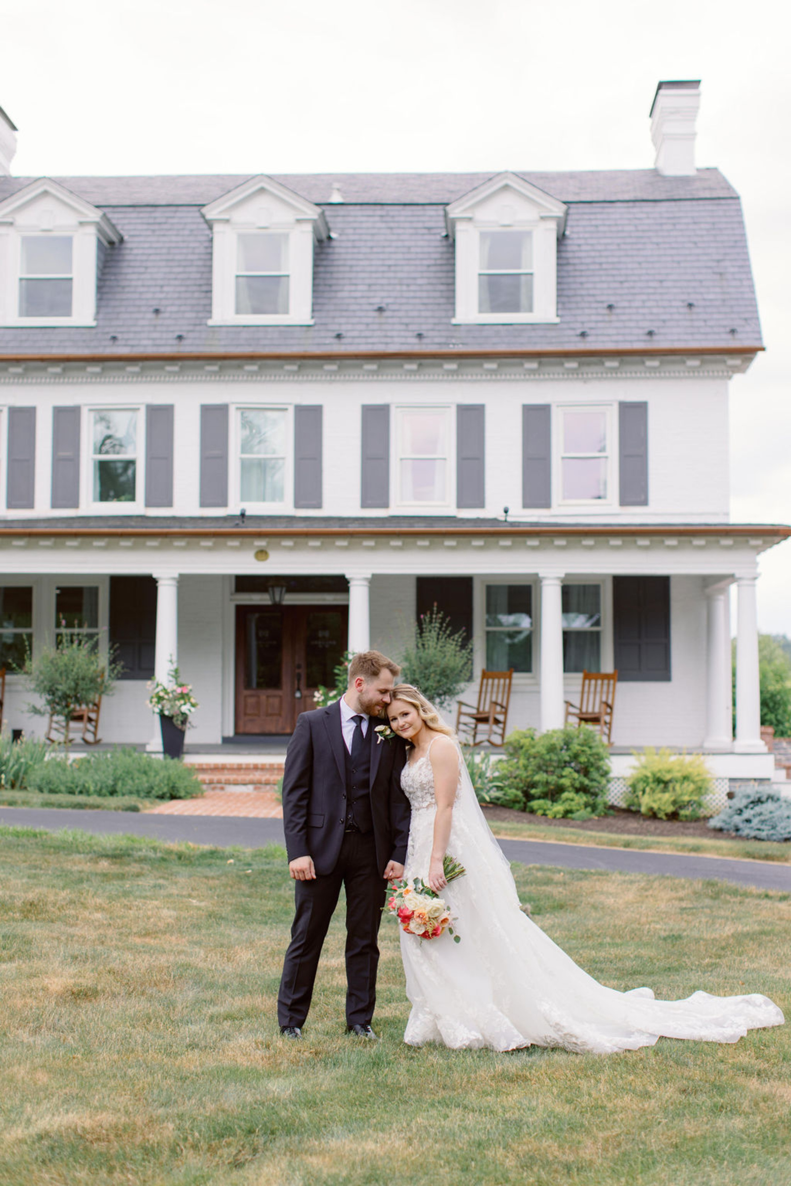 Bride and groom standing together in front of Historic Ashland during romantic outdoor wedding portraits in Central Pennsylvania.