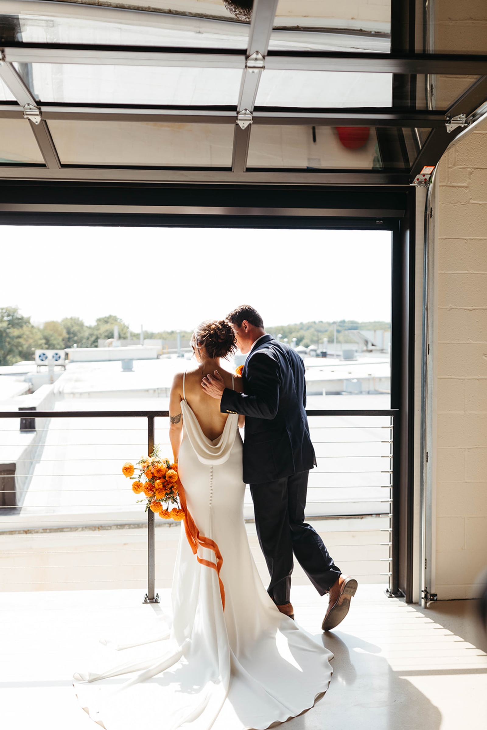 Bride and Groom at The Booking House Bride and groom standing together by an open garage door at The Booking House in Manheim, PA.