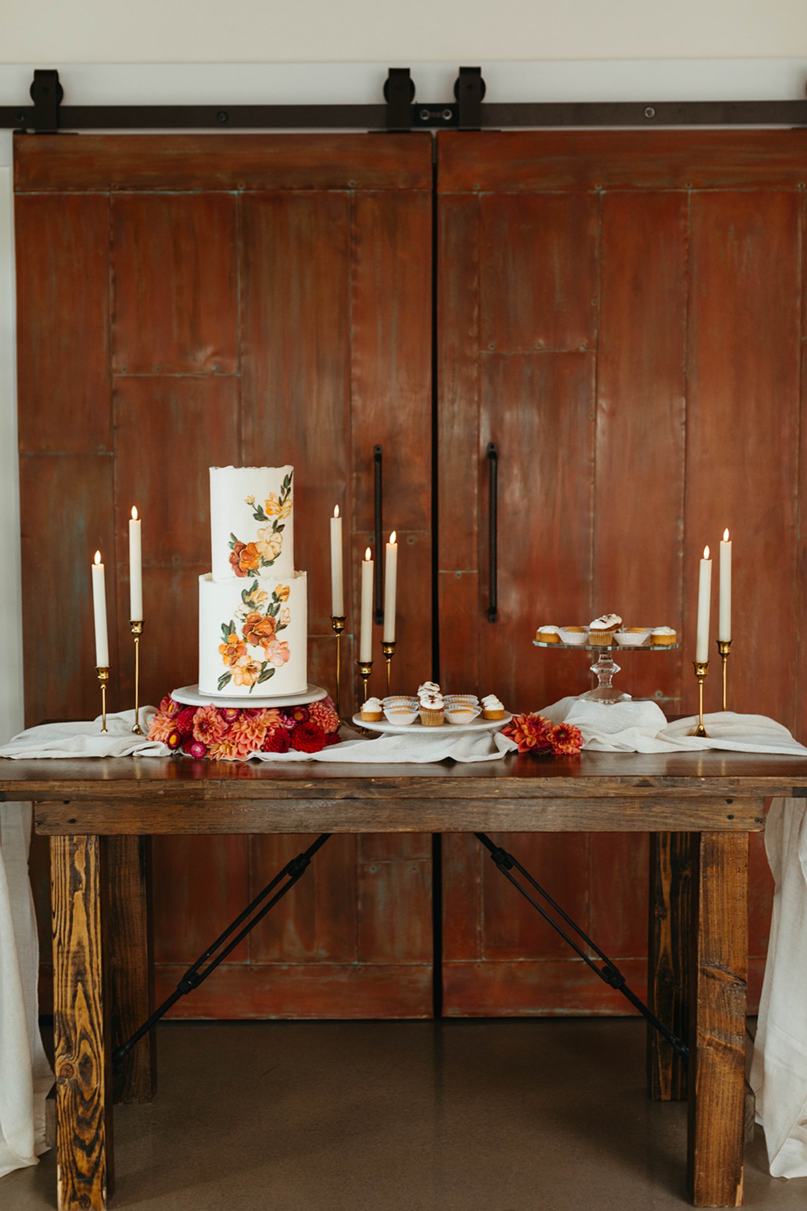 Floral Wedding Cake at The Booking House Floral wedding cake and dessert display with taper candles at The Booking House in Manheim, Pennsylvania.