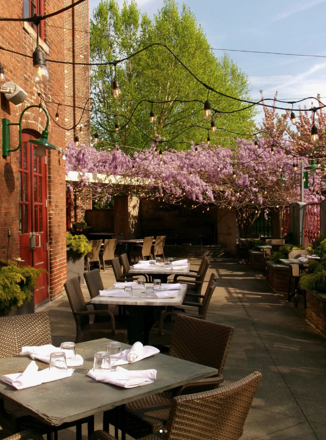 Outdoor Patio at John J. Jeffries in Lancaster Outdoor patio dining at John J. Jeffries in Lancaster, Pennsylvania, featuring string lights and blooming wisteria, ideal for a rehearsal dinner.