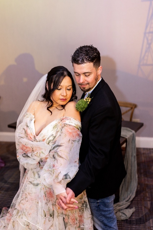 Romantic Western Wedding Portrait The bride and groom share an intimate moment, holding hands and leaning close beneath soft sunset lighting that captures the rustic romance of this Oklahoma!-inspired wedding shoot.