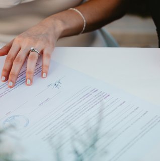Bride and groom signing their Pennsylvania marriage license during an intimate wedding ceremony.