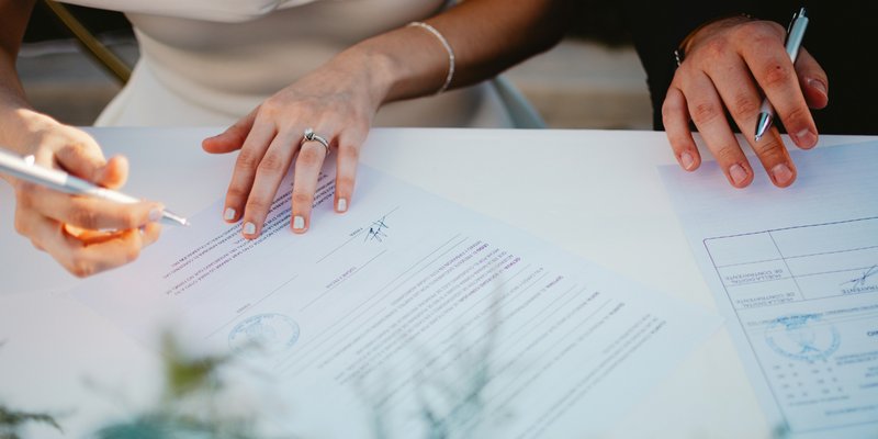 Bride and groom signing their Pennsylvania marriage license during an intimate wedding ceremony.