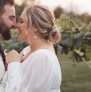 Bride and groom holding hands in the greenhouse of St. Michael's Vineyard at Stone Gables Estate