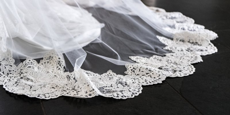 Custom lace wedding veil with detailed floral trim and soft tulle for a romantic bridal look